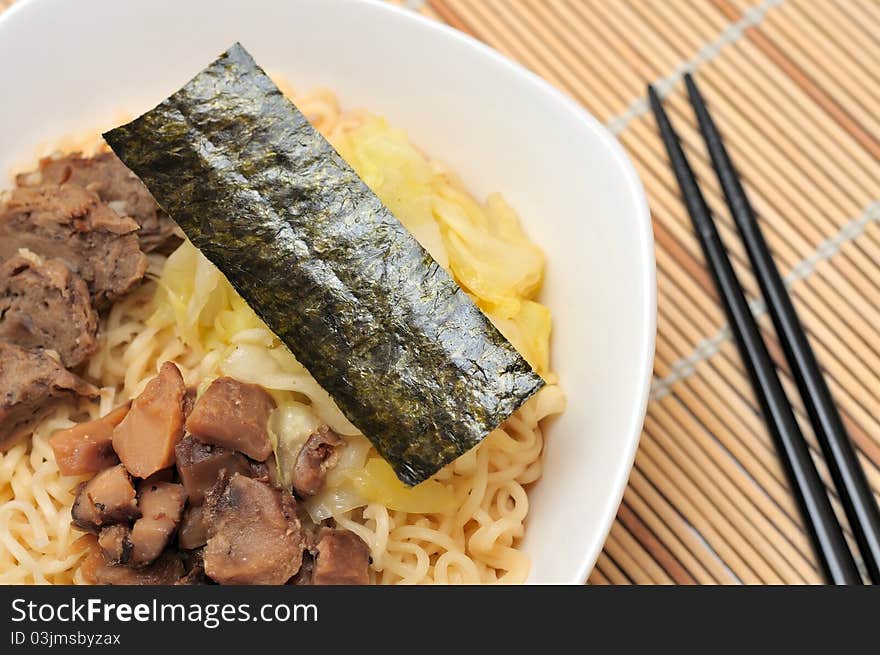 Japanese style yellow noodles served with seaweed. Japanese style yellow noodles served with seaweed.