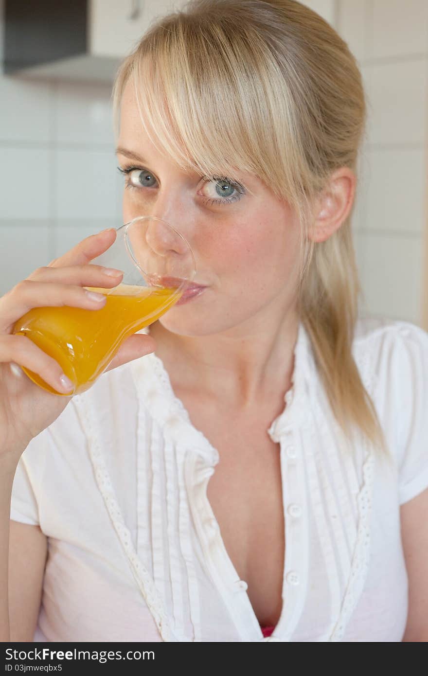 Young blond woman with her breakfast