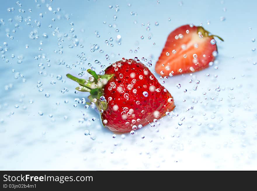 Juicy strawberry in water splash