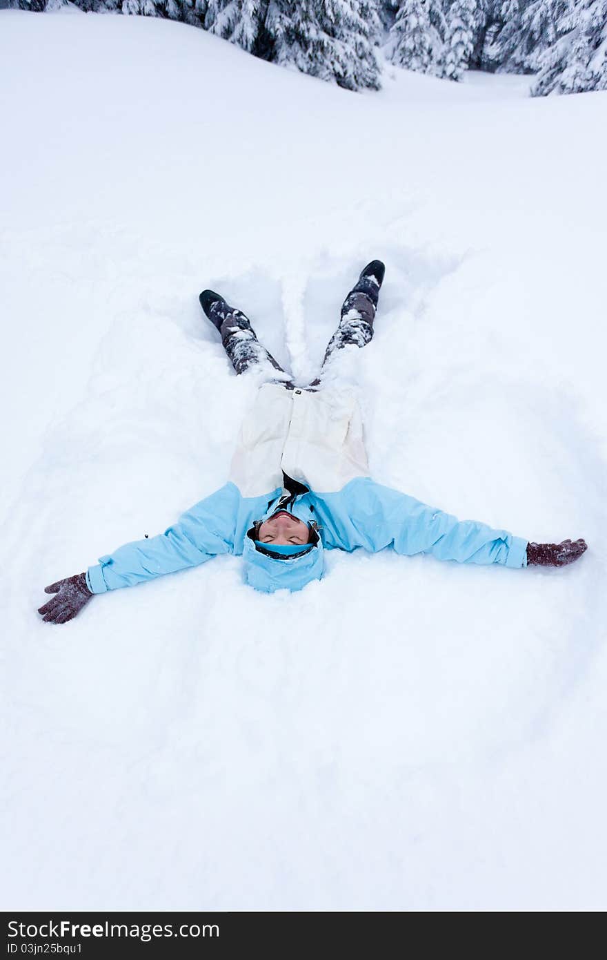 Hiker girl lying in snow. Hiker girl lying in snow