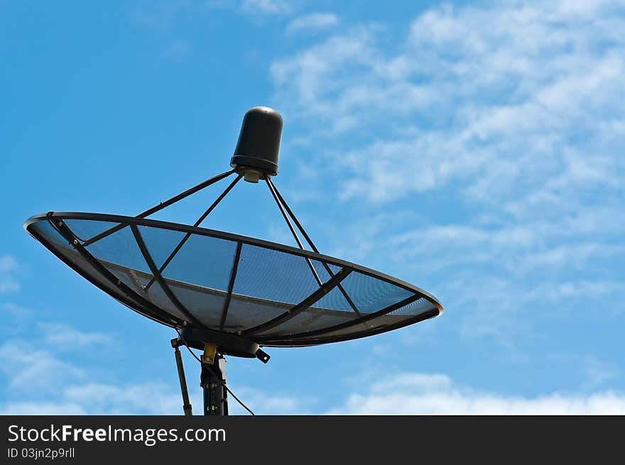 Black satellite dish with blue sky