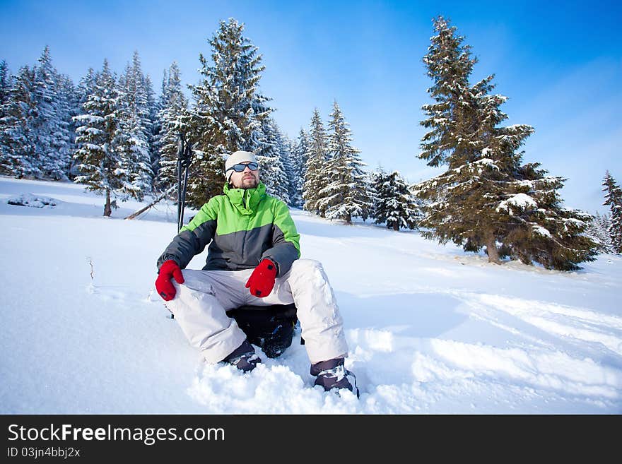 Hiker took a rest in snow forest. Hiker took a rest in snow forest