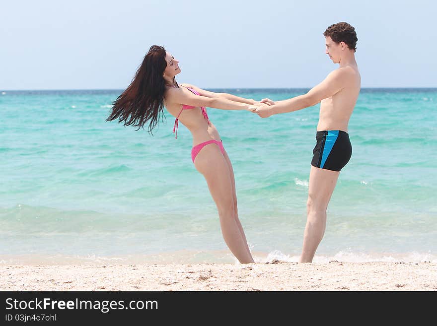 Young happy couple on beach. Young happy couple on beach