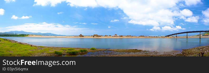 Broad view of summer beach with clouds and blue sky. Broad view of summer beach with clouds and blue sky