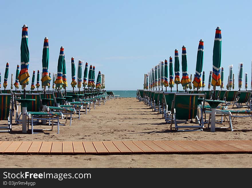 Rows of sun-lounger and sunshades on the beach. Rows of sun-lounger and sunshades on the beach