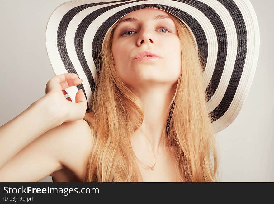 Beautiful young attractive woman posing in a summer hat. Beautiful young attractive woman posing in a summer hat