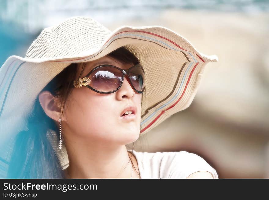 Closeup portrait of a Chinese beautiful girl, with sun glasses and hat. Closeup portrait of a Chinese beautiful girl, with sun glasses and hat