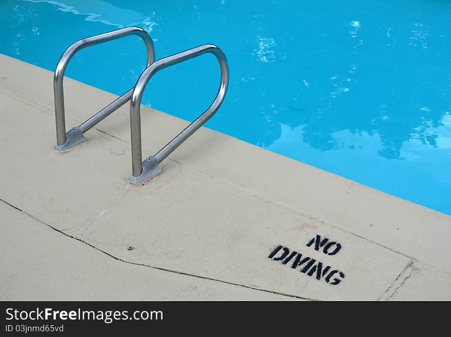 Pool entry and exit with a no diving sign