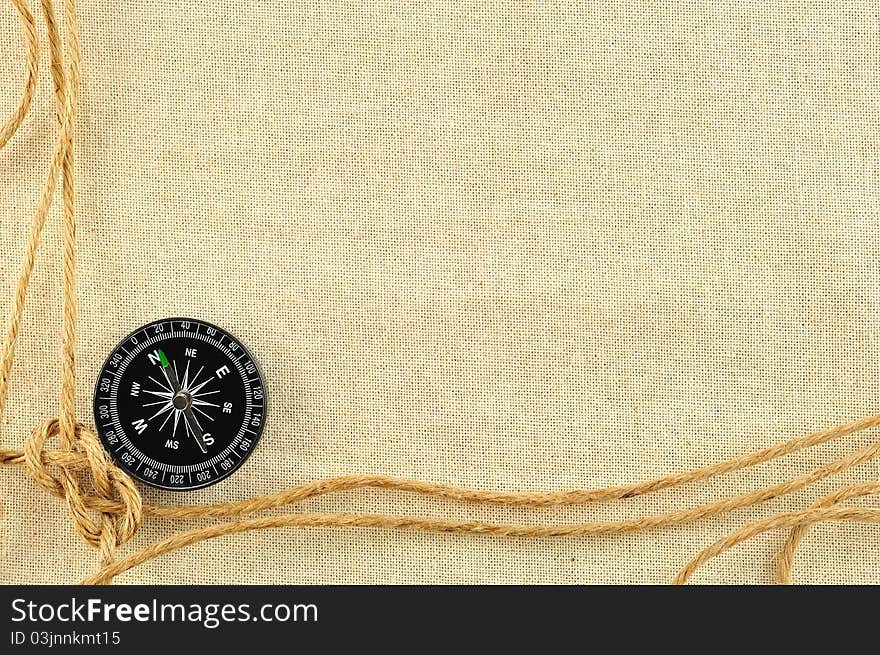 Compass and rope on with a canvas of burlap