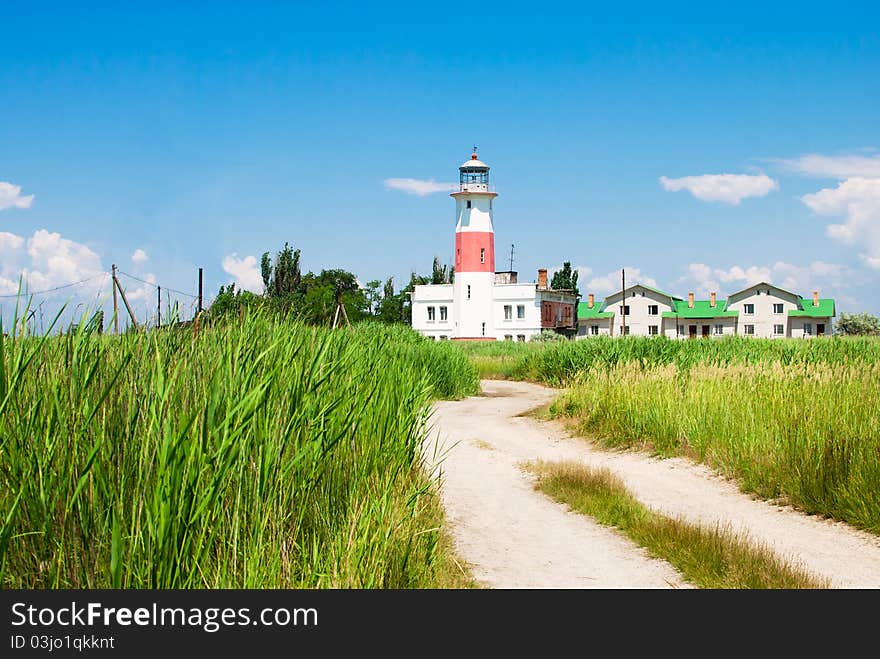 Road in reed to the old lighthouse. Octagonal masonry tower with red and white bands. It is situated in the North side of Sea of Azov, Zaporizhia Oblast to provide active aid to navigation.