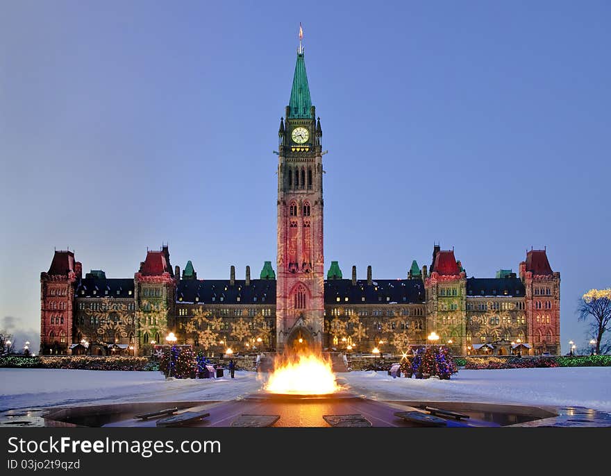 The Centre Block and the Centennial flame decorated for Christmas at dusk. The Centre Block and the Centennial flame decorated for Christmas at dusk