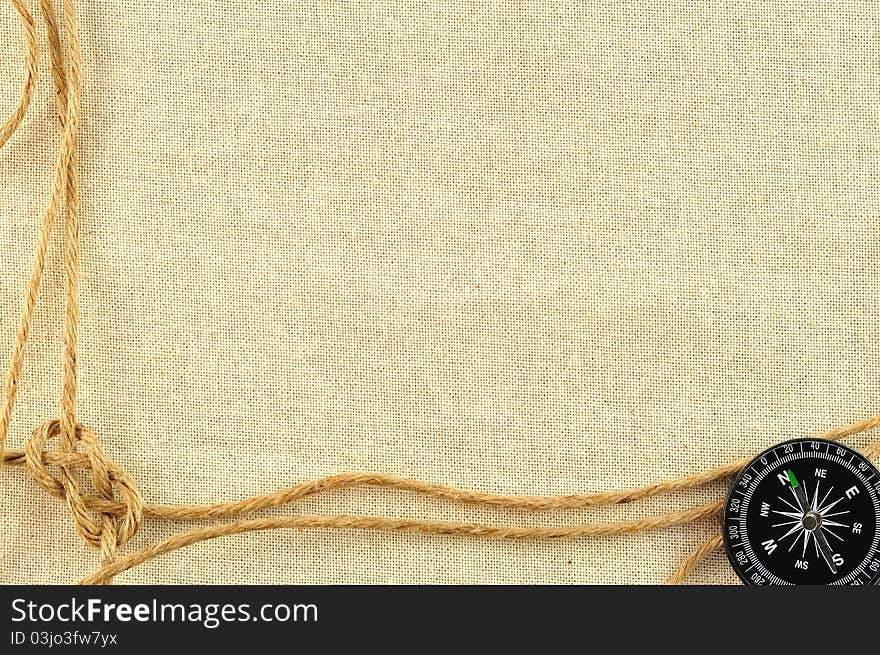 Compass and rope on with a canvas of burlap