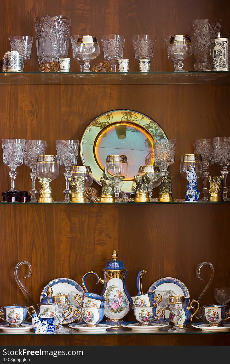 Decorative ware adorning glass shelves in the living room cabinet. Decorative ware adorning glass shelves in the living room cabinet