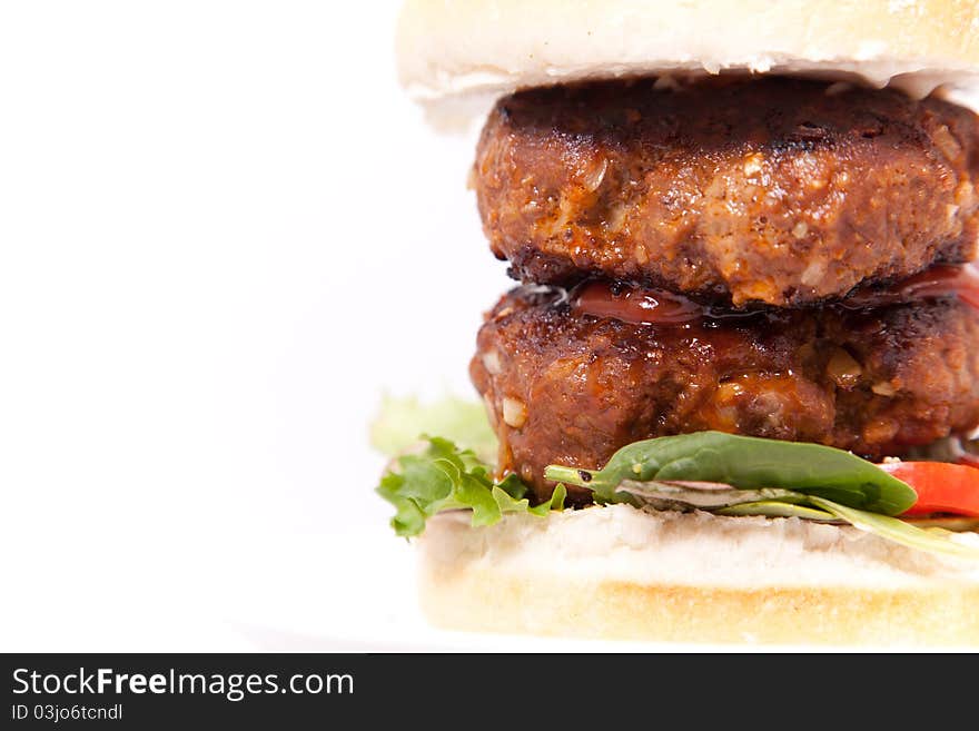 Macro picture of double beef burger in white background.