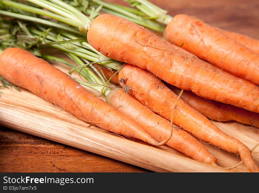 Close up picture of carrots on wooden table