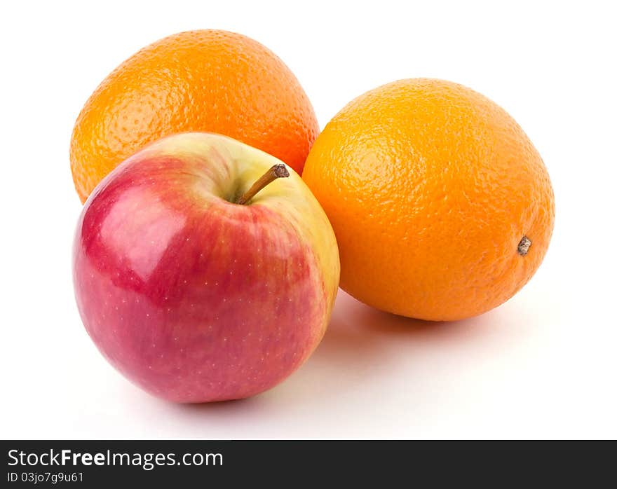 Two oranges and juicy apple isolated on white background