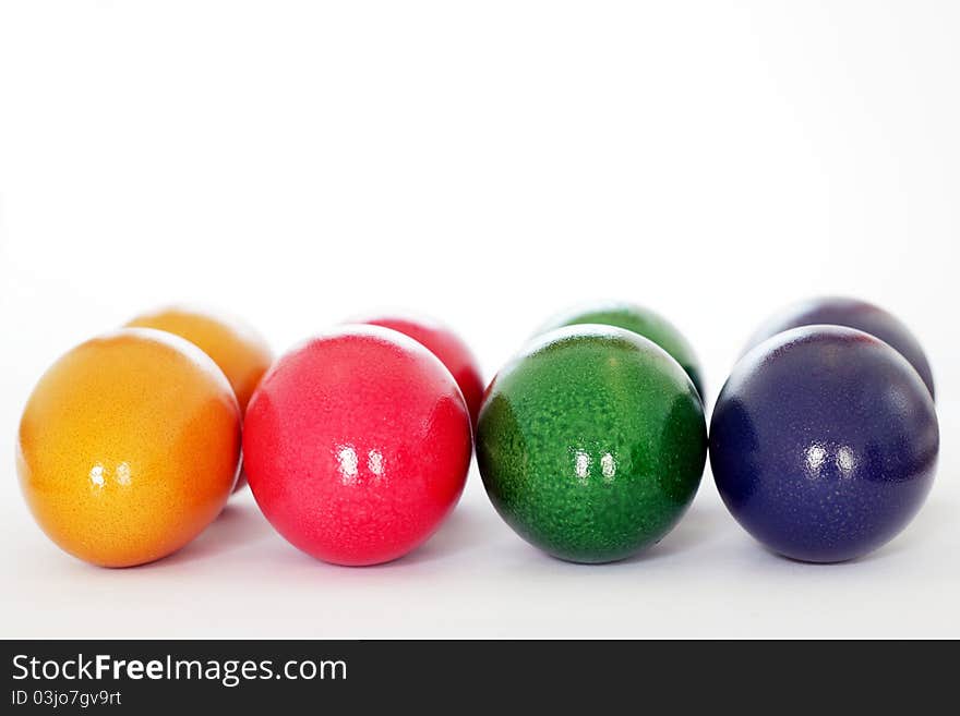 Strung colorful easter eggs isolated on white background