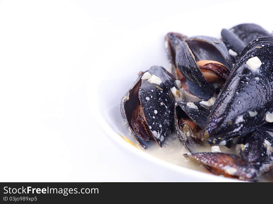 Mussels in the bowl in white background.