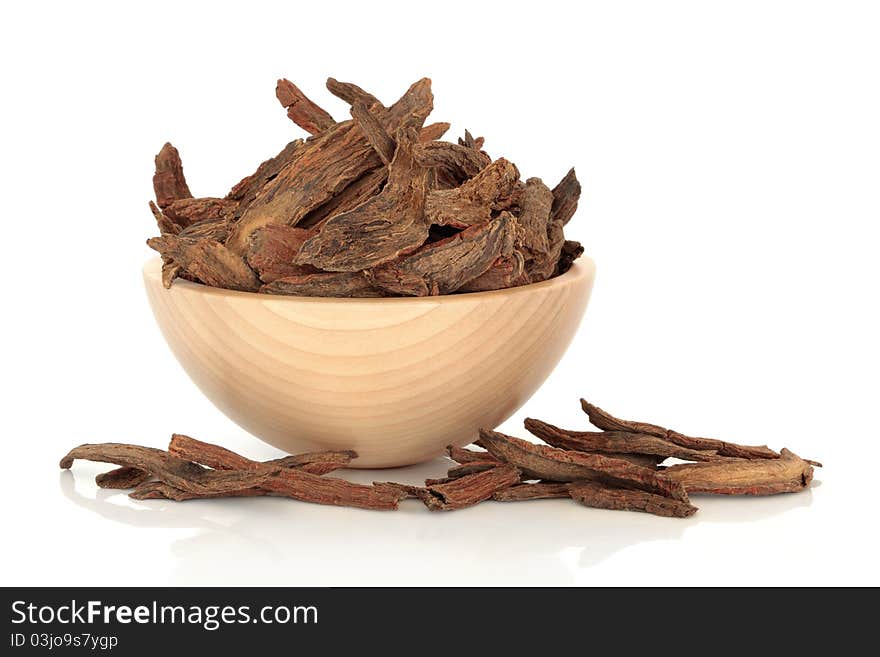 Lophatherum stems used in chinese herbal medicine in a beech wood bowl isolated over white background. Dan shen. Radix codonpsotis pilosulae. Lophatherum stems used in chinese herbal medicine in a beech wood bowl isolated over white background. Dan shen. Radix codonpsotis pilosulae.