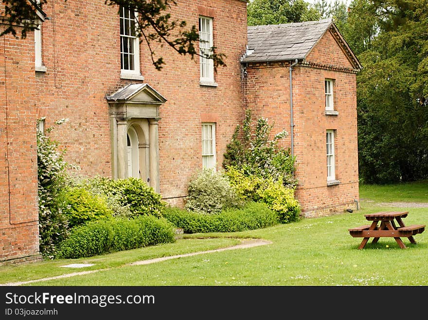 A building in the Shugborough estate Staffordshire England, the home of Lord Lichfield. Showing park bench. A building in the Shugborough estate Staffordshire England, the home of Lord Lichfield. Showing park bench.