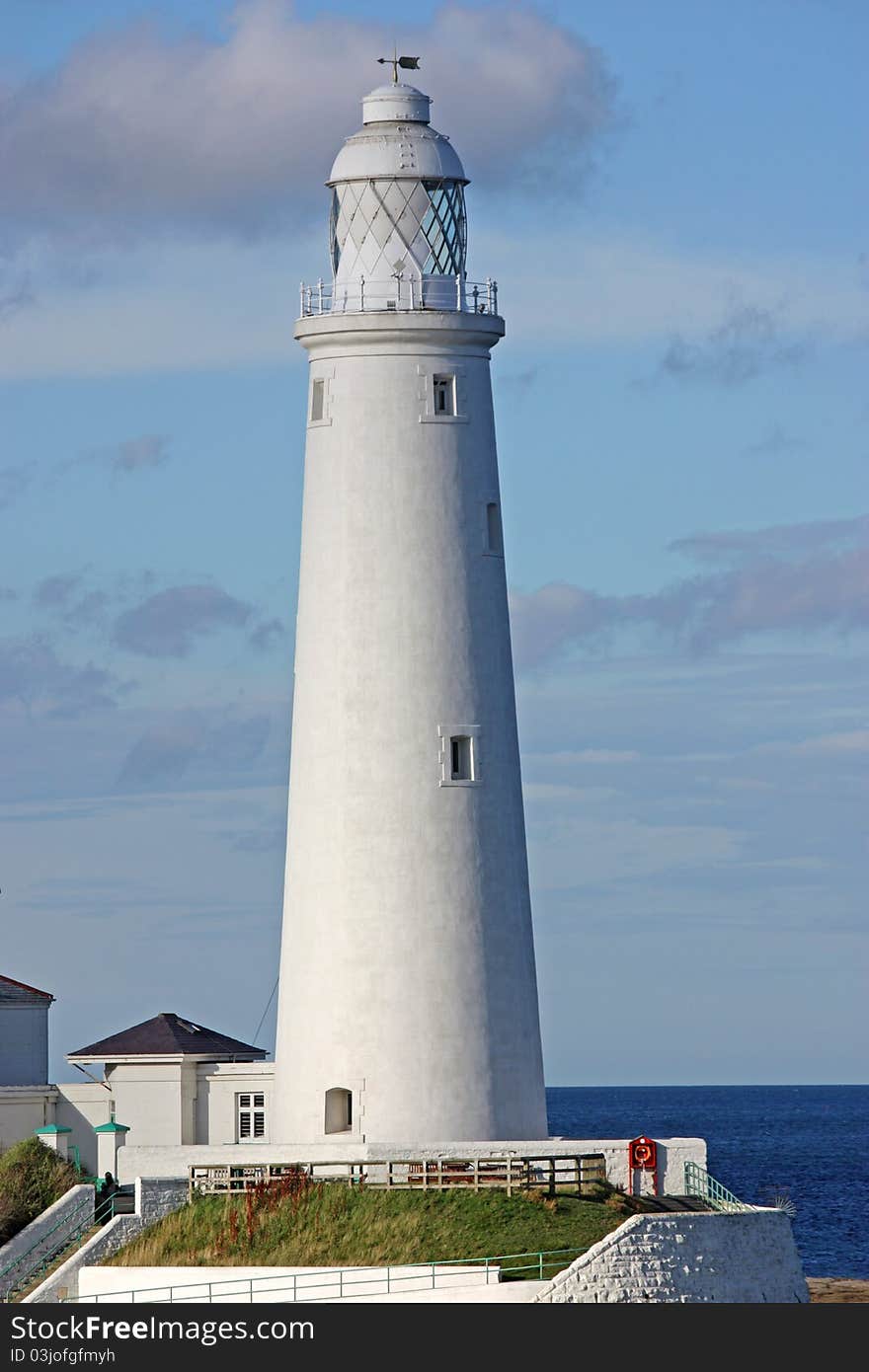 A Traditional Tall British Coastal White Lighthouse.