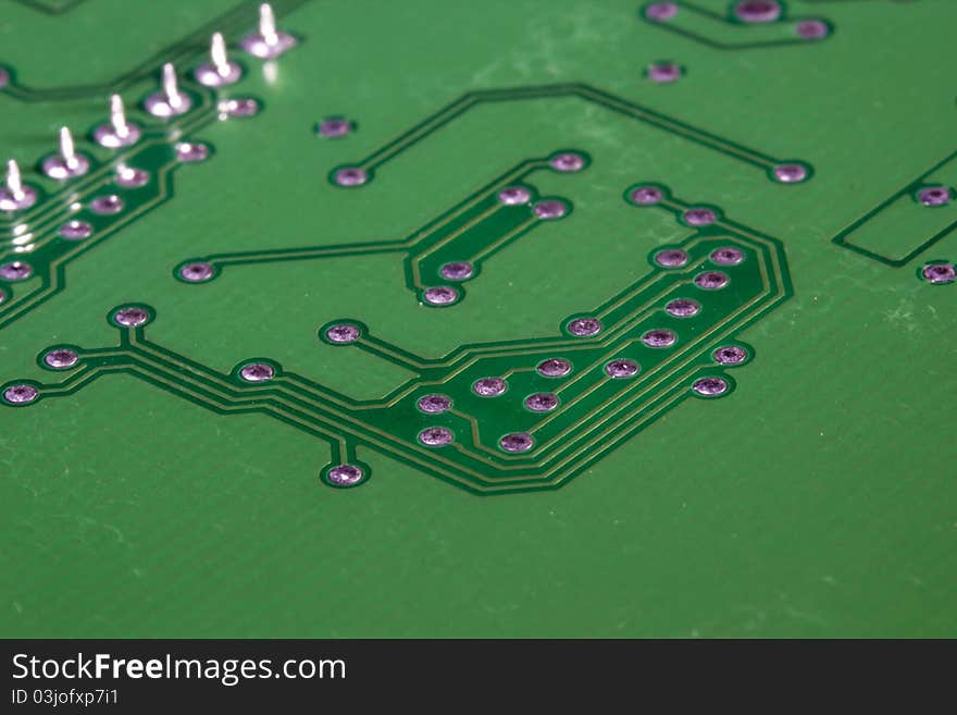 Close-up photograph of a green circuit board.