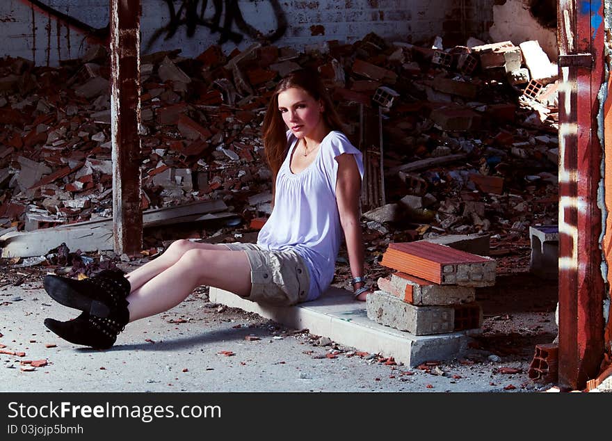 One beautiful woman is sit in a place surrounded by bricks. 
The location looks like abandoned and it is on ruins. The girl is looking straight to the camera. She dresses one short, boot and one clear t-shirt. One beautiful woman is sit in a place surrounded by bricks. 
The location looks like abandoned and it is on ruins. The girl is looking straight to the camera. She dresses one short, boot and one clear t-shirt.