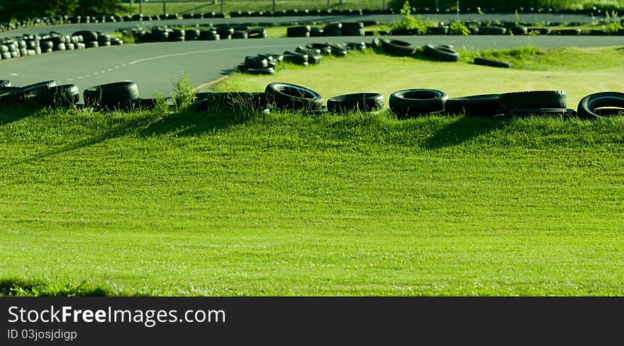 Tires being used as a safety barrier on go-cart track. Tires being used as a safety barrier on go-cart track