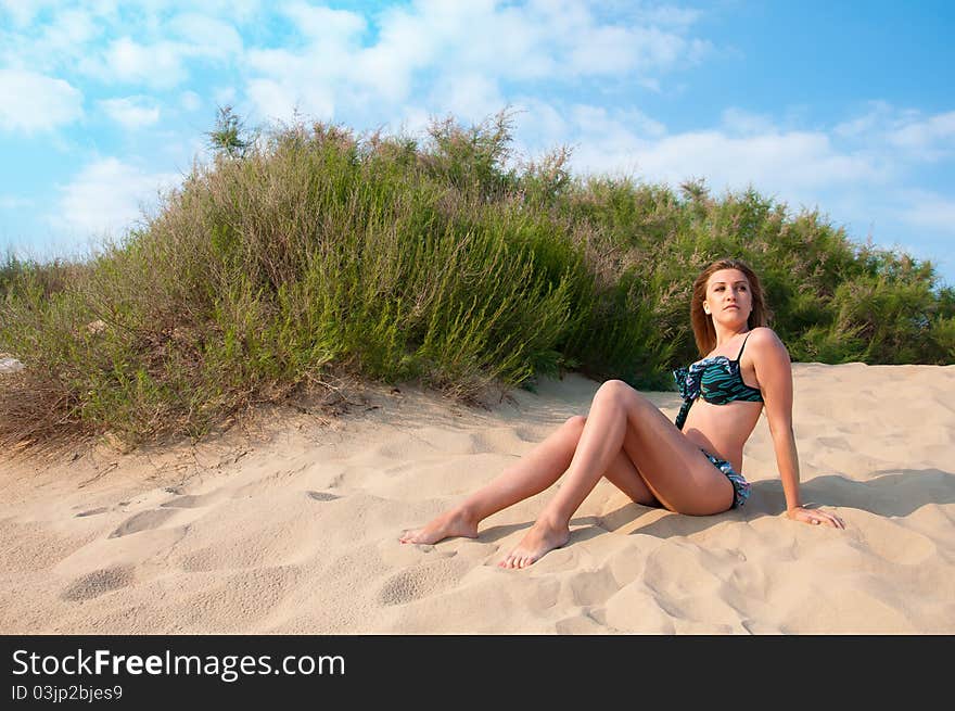 Woman in swimsuit on the sand