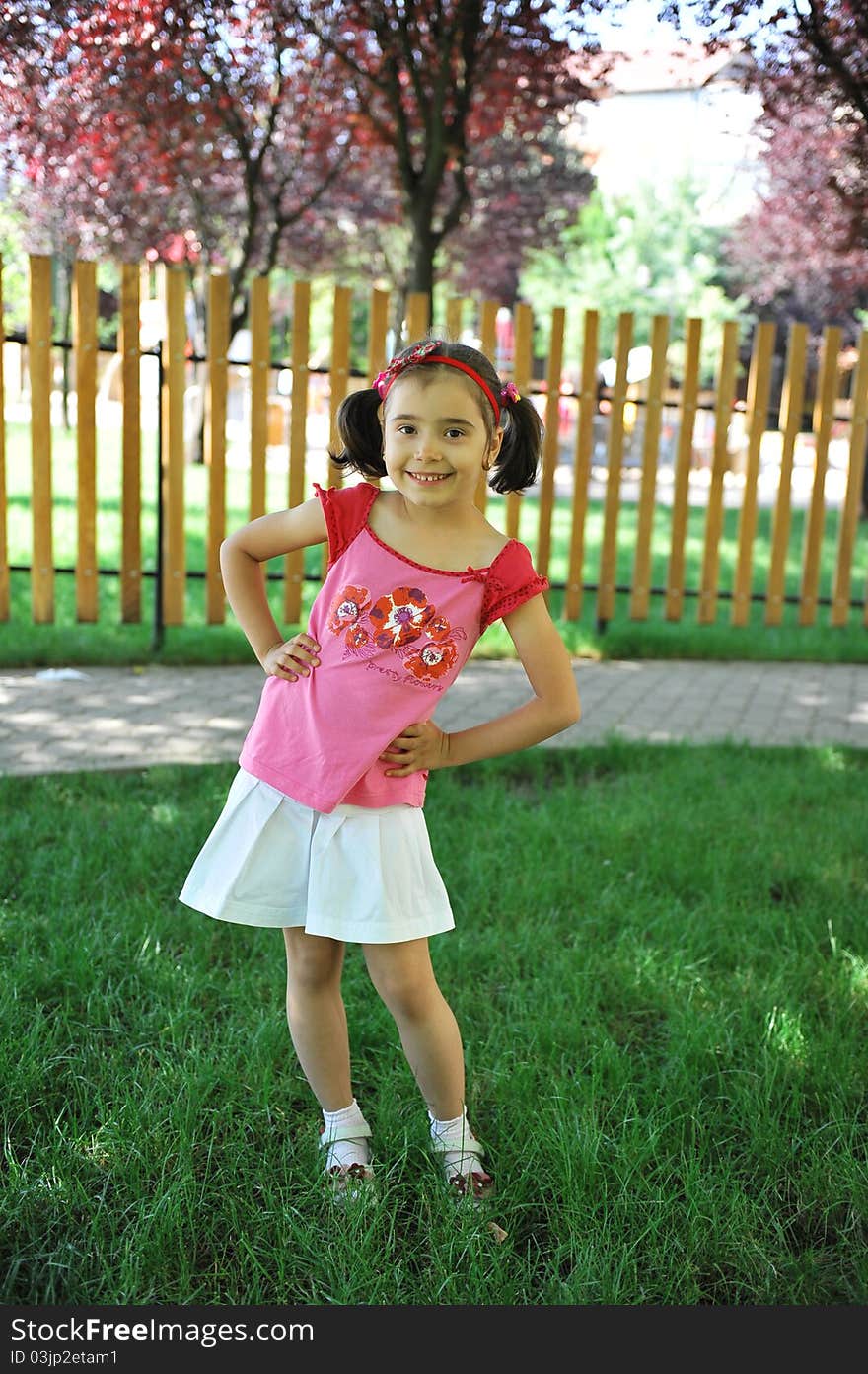 Cute little girl does outdoor fashion photo shoot