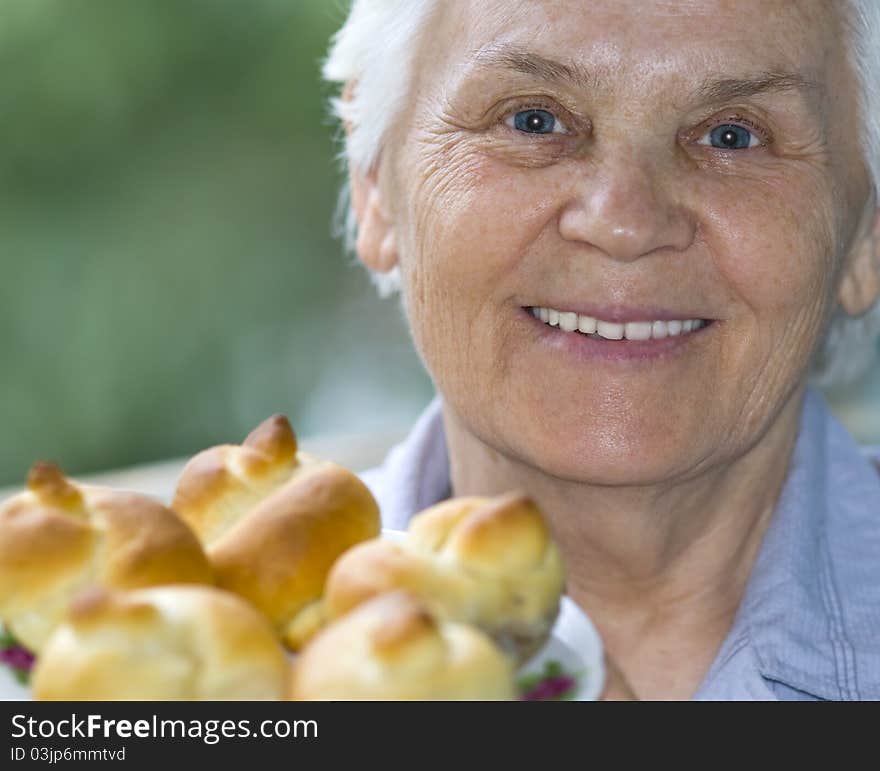 Joyful woman with cakes in the background. Joyful woman with cakes in the background