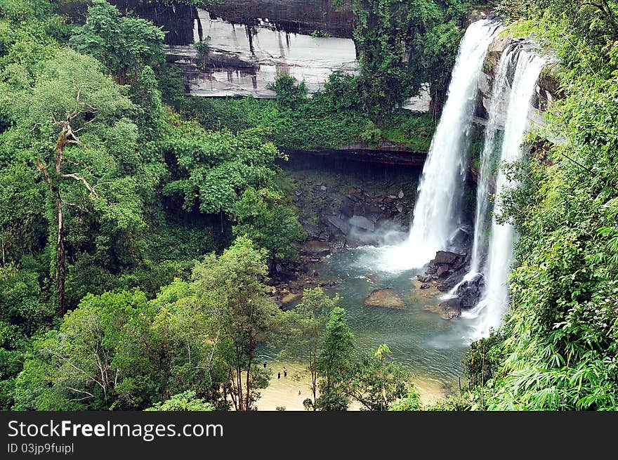 A 200 feet height Waterfall in ubonrachathani in Thailand . You can see a few people below to compare the size of it. A 200 feet height Waterfall in ubonrachathani in Thailand . You can see a few people below to compare the size of it.