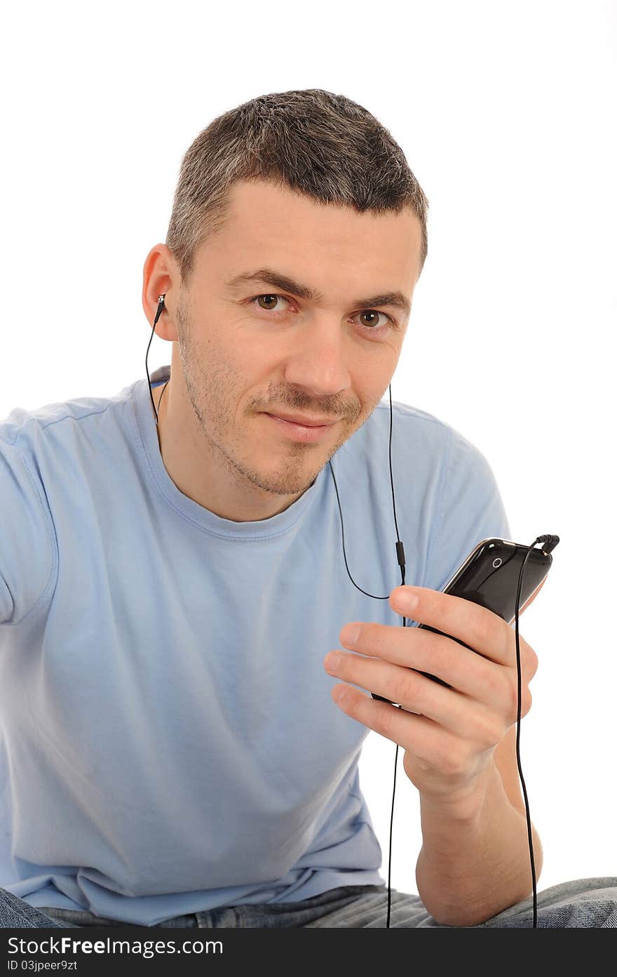 Casual young man with cell phone and headphones. isolated. Casual young man with cell phone and headphones. isolated