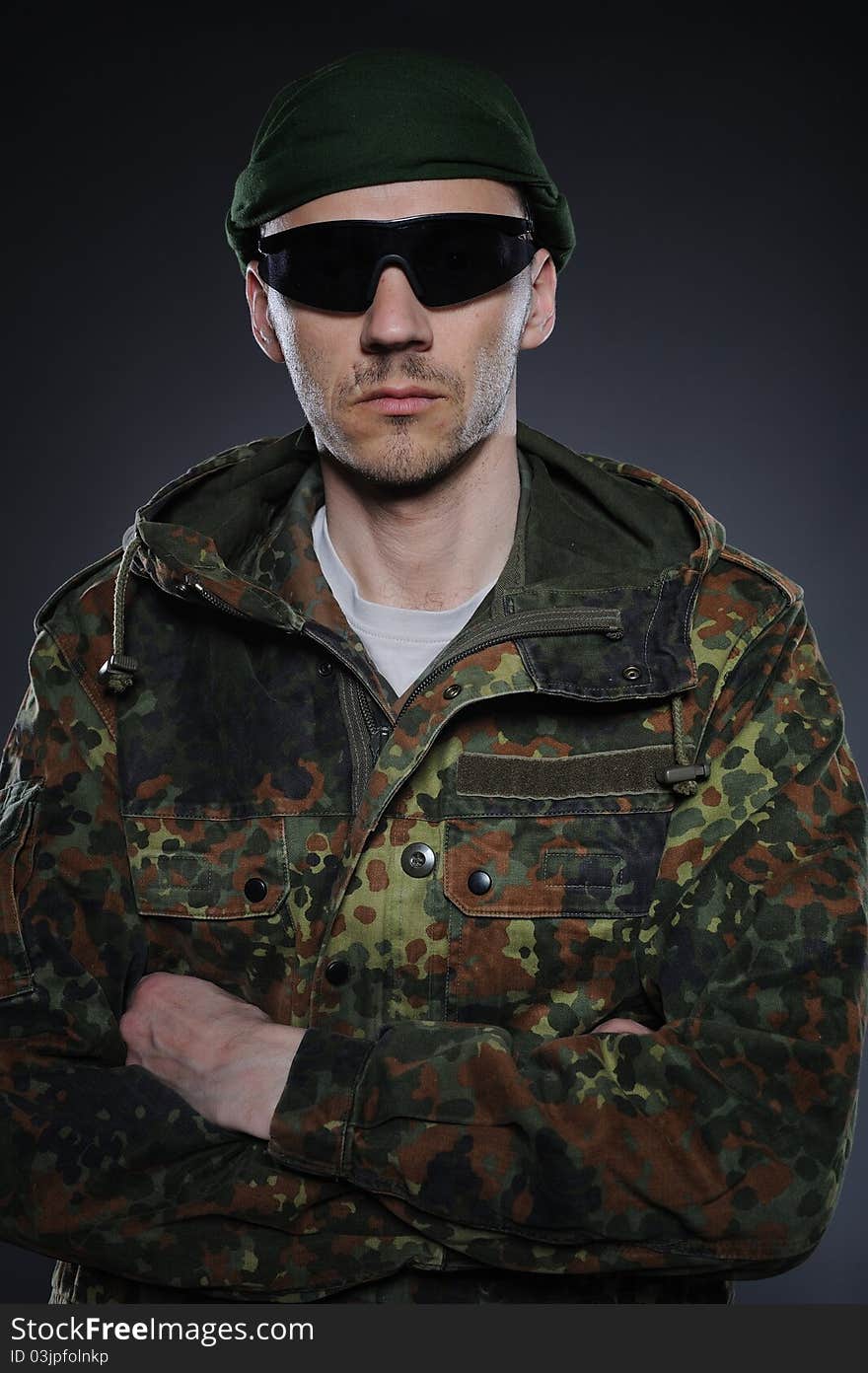 Soldier in camouflage and ammunition