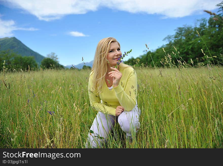 Beautiful natural woman with pure healthy skin outdoors on spring field. Switzerland. Beautiful natural woman with pure healthy skin outdoors on spring field. Switzerland