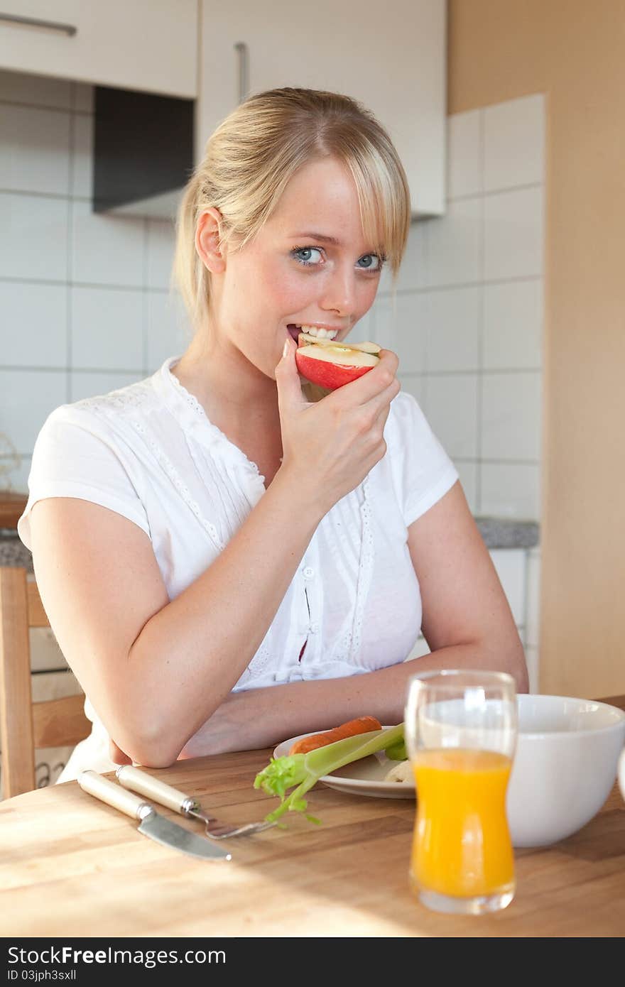 Young blond woman with her breakfast