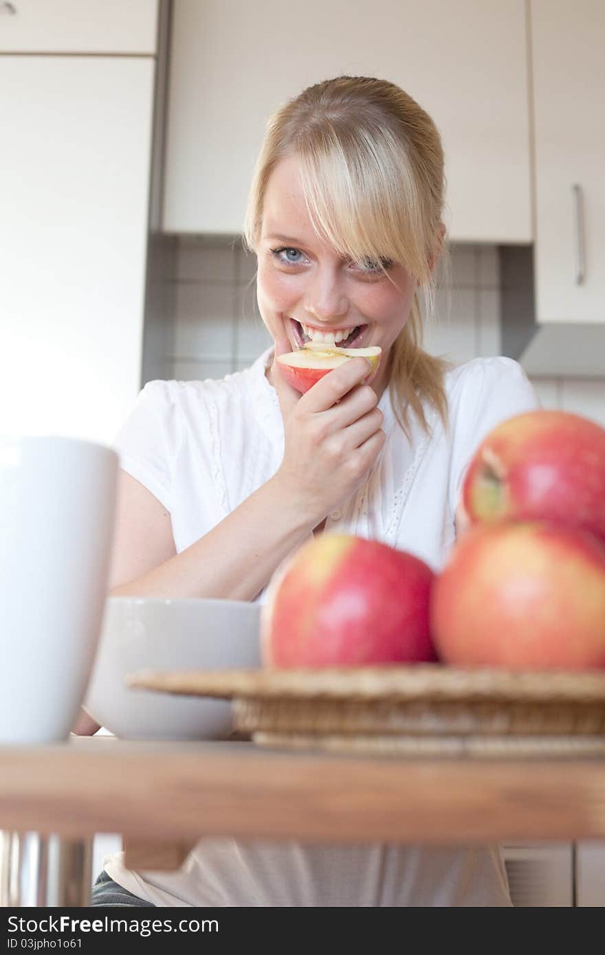 Young blond woman with her breakfast