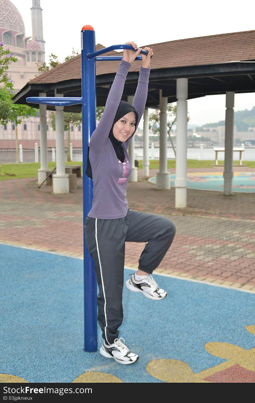 Young woman doing outdoor exercises. Young woman doing outdoor exercises