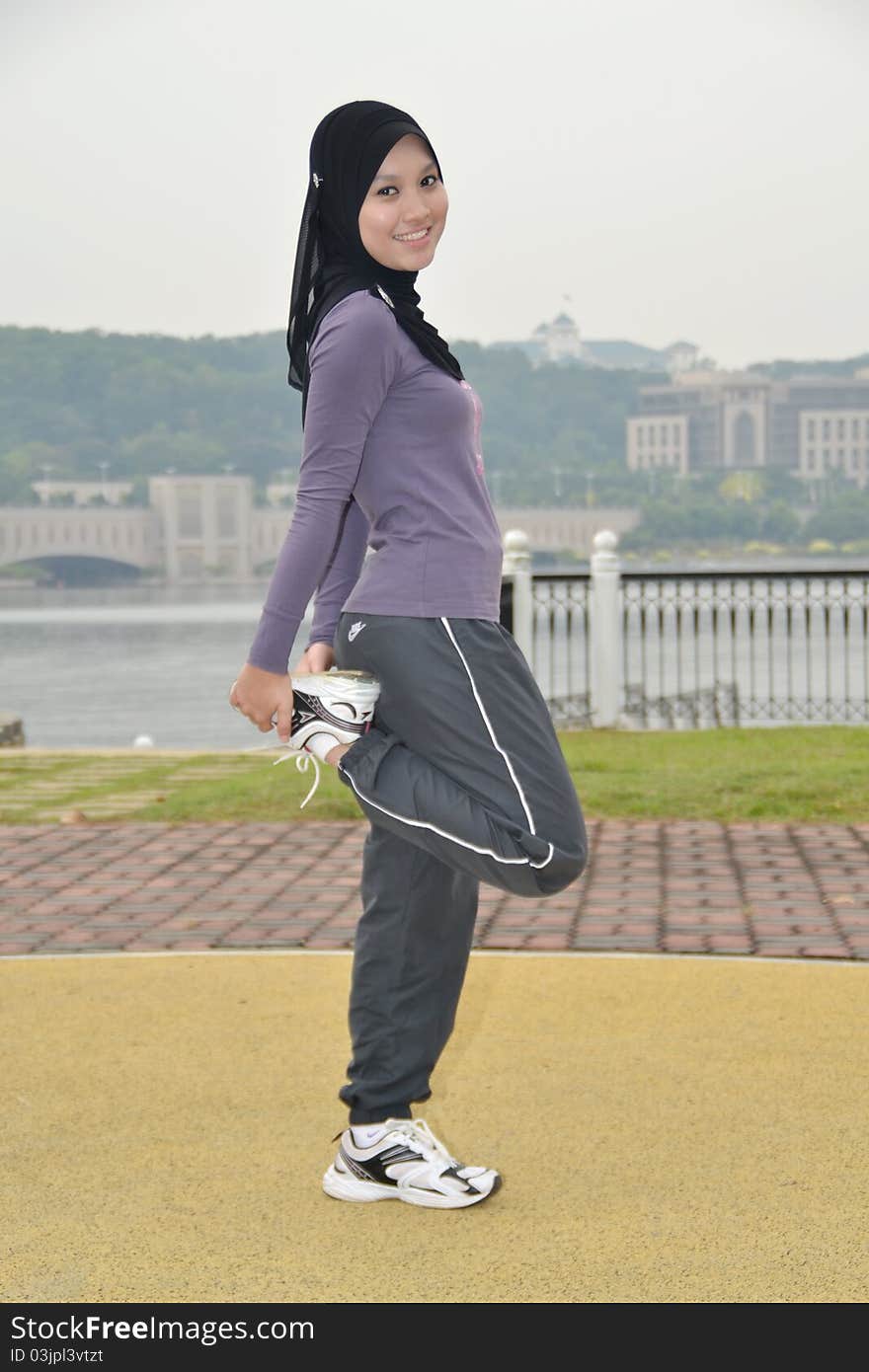 Young woman doing outdoor exercises. Young woman doing outdoor exercises