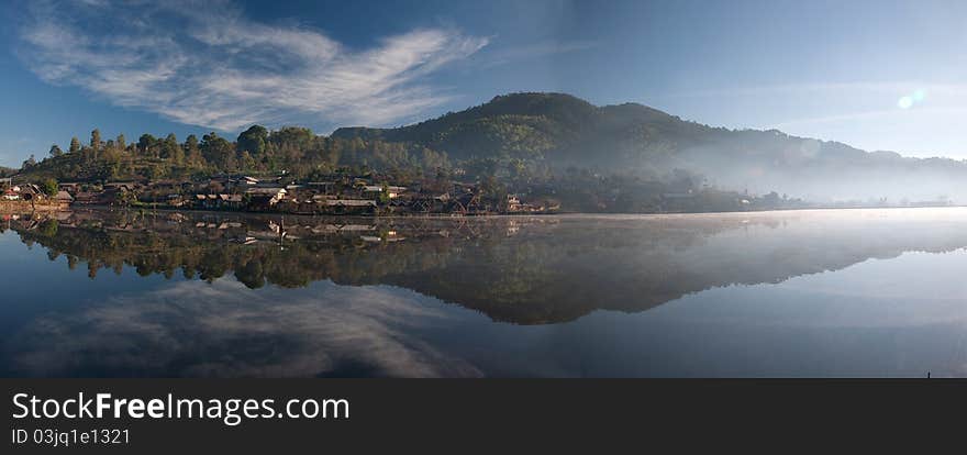 View of one village is located close to a lake also has mountain on background. View of one village is located close to a lake also has mountain on background.