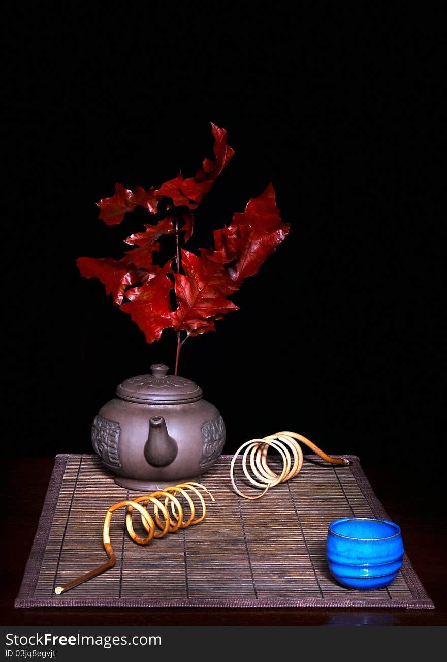 Still life with tea plates on straw mat