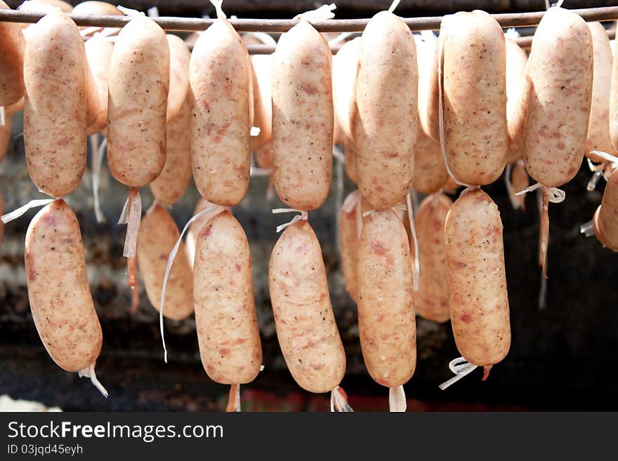 Sausage hanging  under sunlight to make good tasty. Sausage hanging  under sunlight to make good tasty.