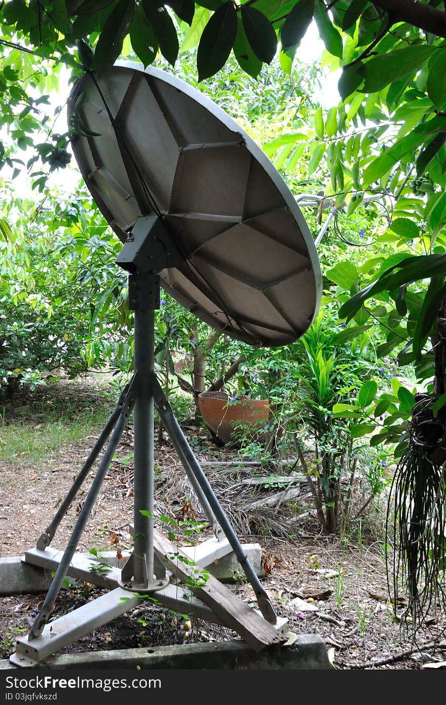 A satellite dish next to the house.