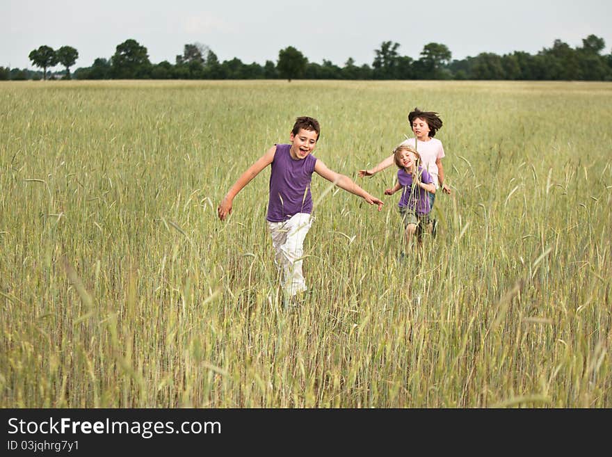 Tree boy running through a fields. Tree boy running through a fields