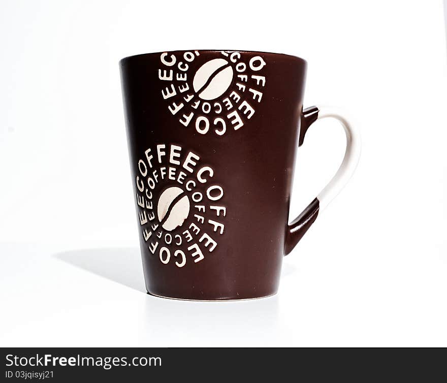 Brown coffee cup in the studio on a white table