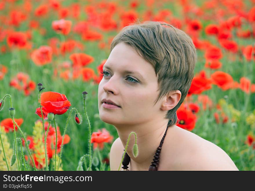 The girl in the field of poppies in the spring. The girl in the field of poppies in the spring