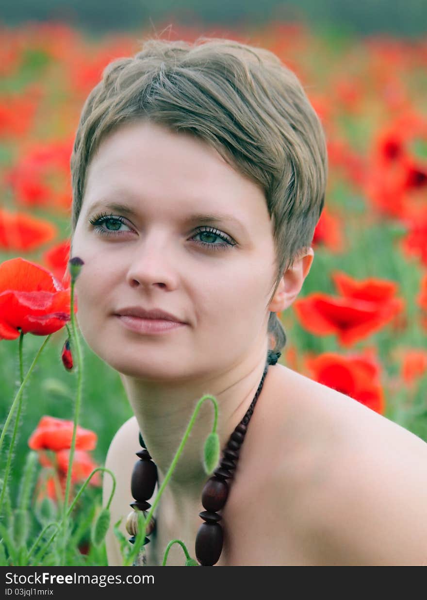 The girl in the field of poppies in the spring. The girl in the field of poppies in the spring