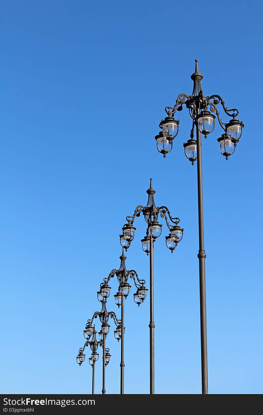 A number of city lights against the blue clear sky. A number of city lights against the blue clear sky.