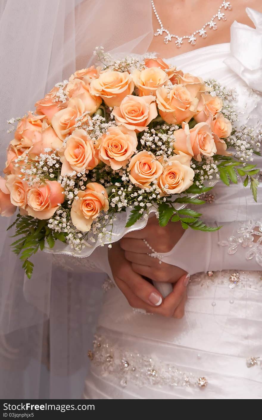 Bride holding orange bouquet detail