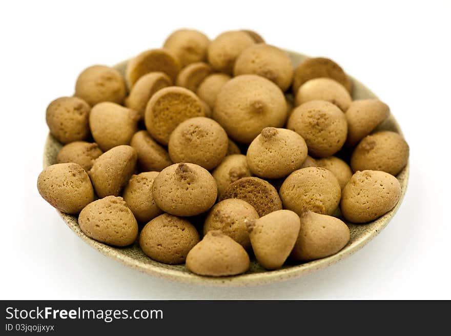 A Saucer of Small hand made Cookies on the White Background. A Saucer of Small hand made Cookies on the White Background